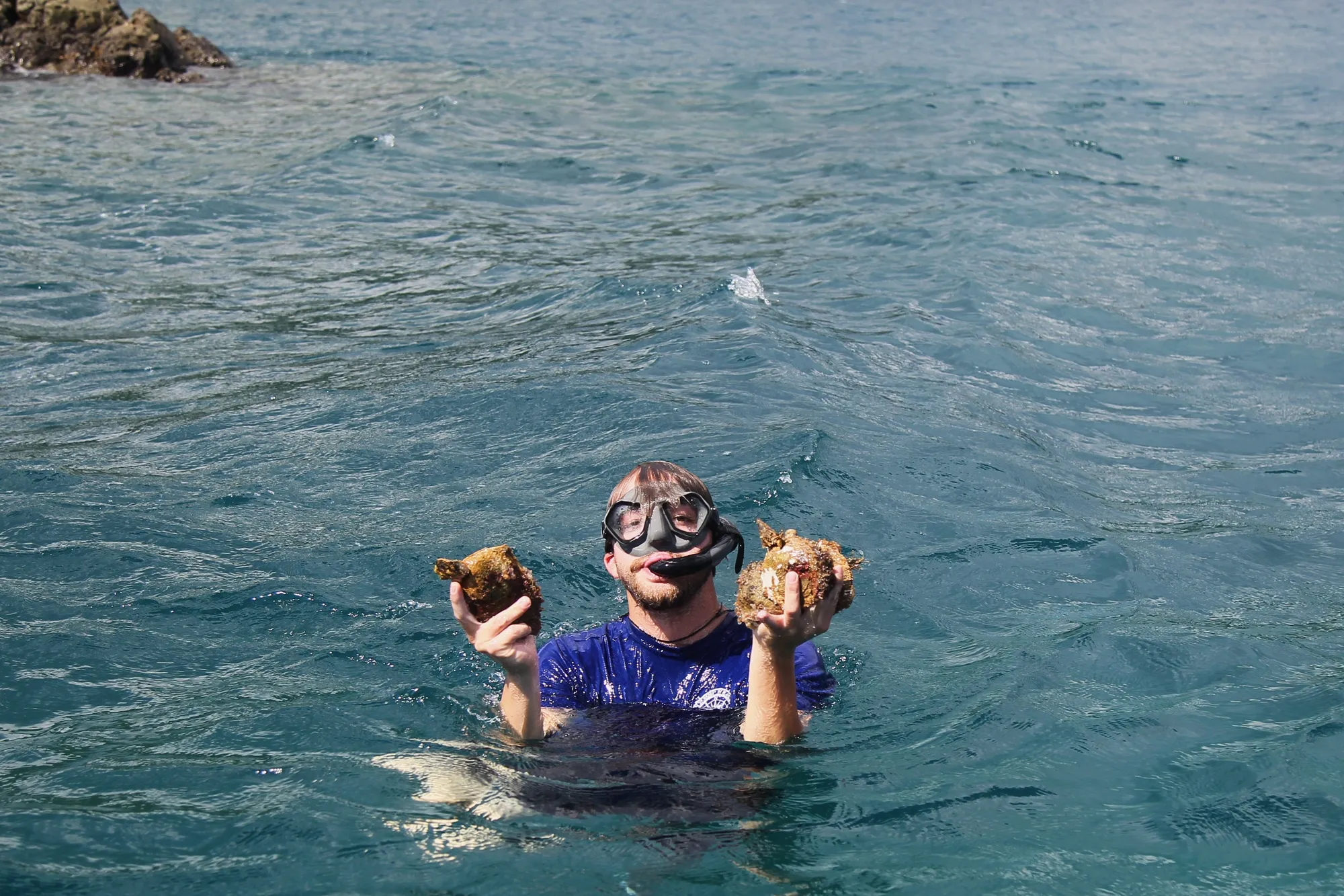 Snorkeling in clear turquoise waters near Playa Zancudo